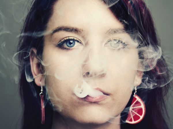 What are the effects of tobacco cigarette smoking on the cornea and tear film layer?